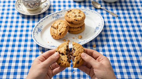 Indulgent Chocolate Chip Cookie Pull: A Close-Up of Freshly Baked Cookies with Melting Chocolate in a French Culinary Style