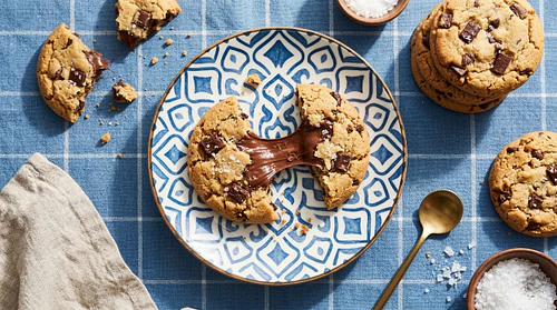 Chocolate Chip Cookie Broken in Half with Gooey Chocolate Pull – Top View Flatlay